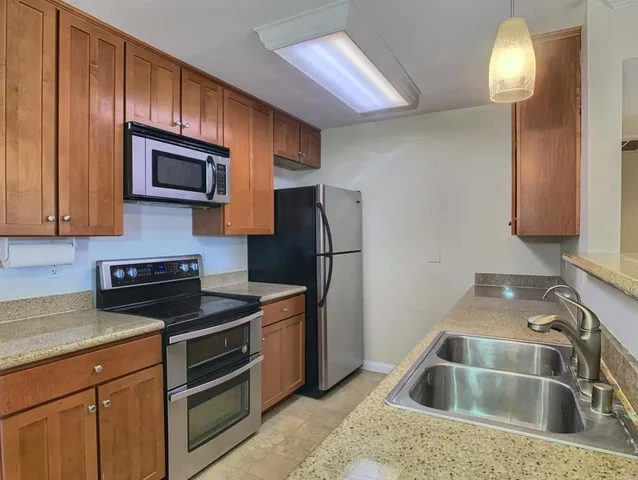 a kitchen with a sink cabinets and stainless steel appliances