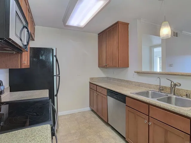 a kitchen with stainless steel appliances granite countertop a refrigerator and a sink