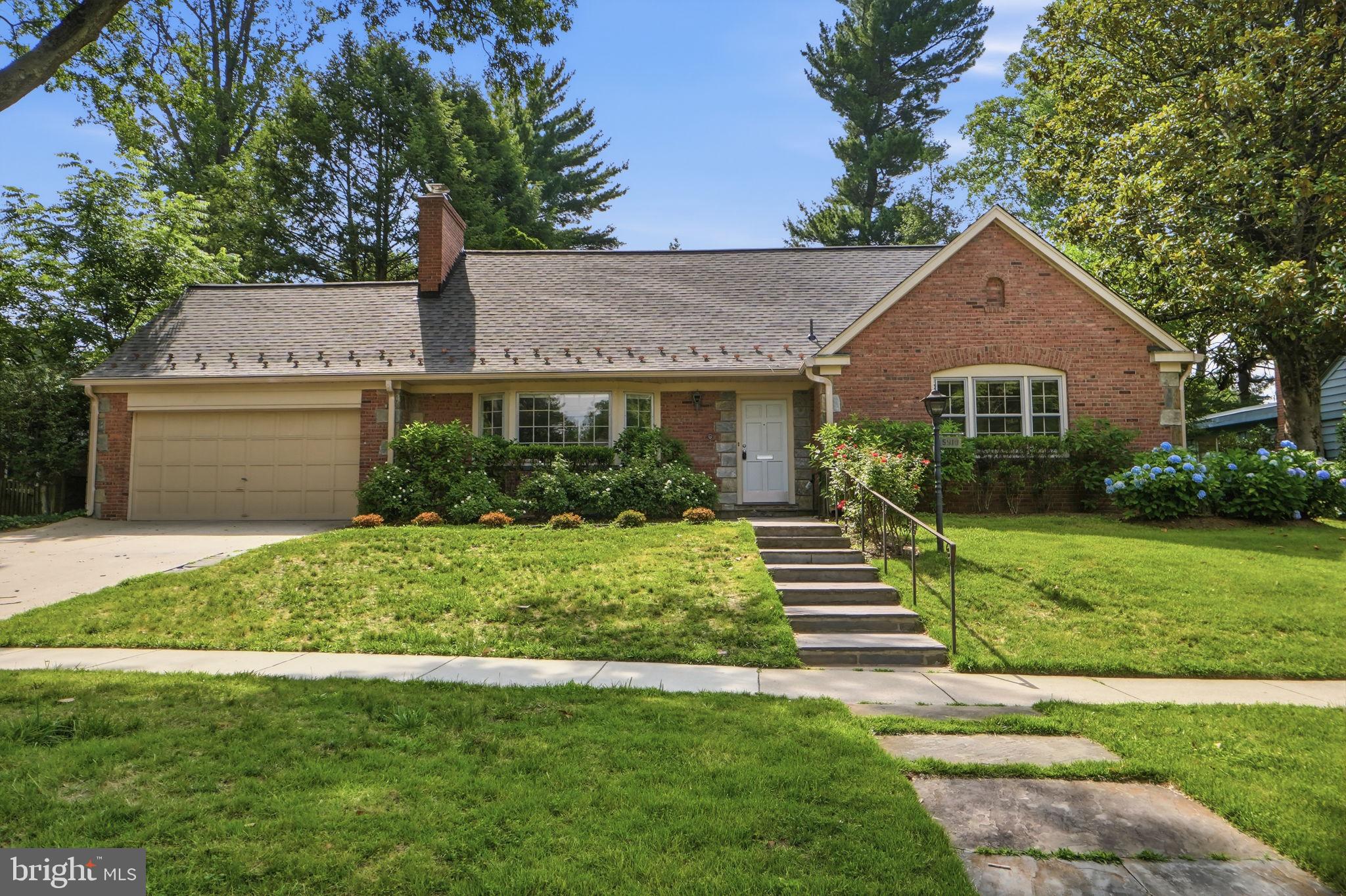 5910 Overlea Road Bethesda, MD 20816 - Photo 1 of 56 a front view of a house with a yard and green space
