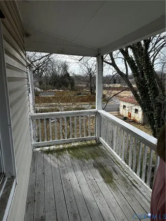 a view of a balcony with wooden floor