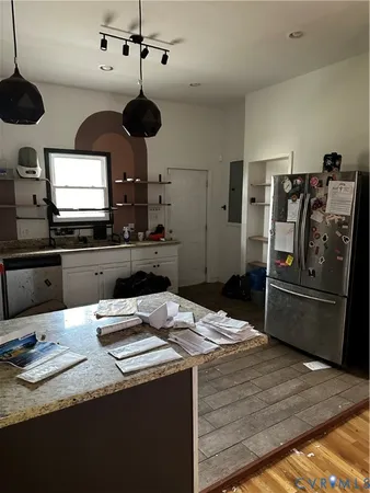 a kitchen with a sink stainless steel appliances and cabinets