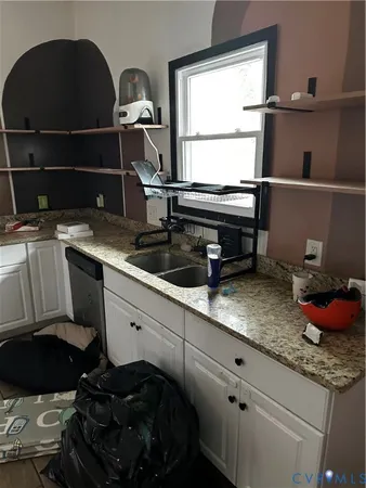 a kitchen with a sink and a stove next to a window