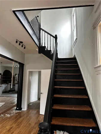 a view of entryway and hall with wooden floor