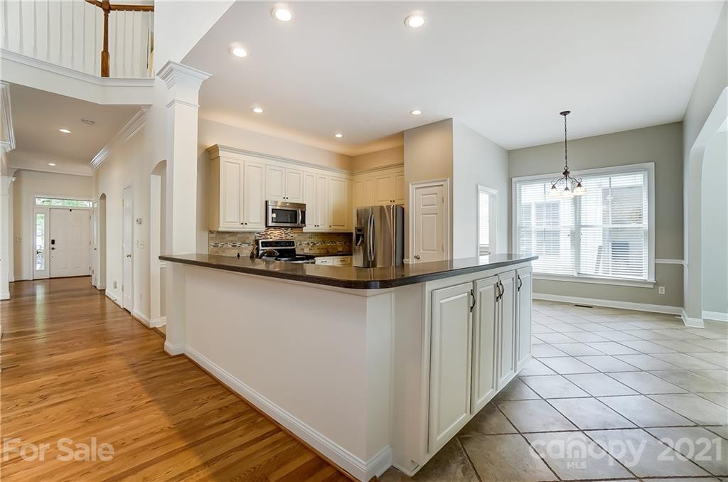 3233 Colonel Springs Way Fort Mill, SC 29708 - Photo 14 of 48 a kitchen with stainless steel appliances granite countertop a refrigerator and a stove top oven