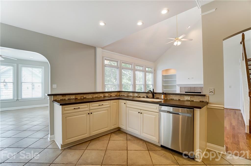 3233 Colonel Springs Way Fort Mill, SC 29708 - Photo 15 of 48 a kitchen with granite countertop a sink stove and cabinets