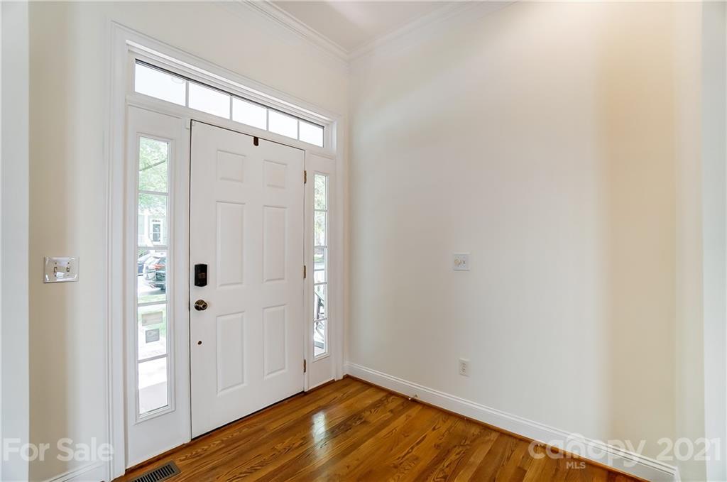 3233 Colonel Springs Way Fort Mill, SC 29708 - Photo 4 of 48 a view of an empty room with wooden floor and a window