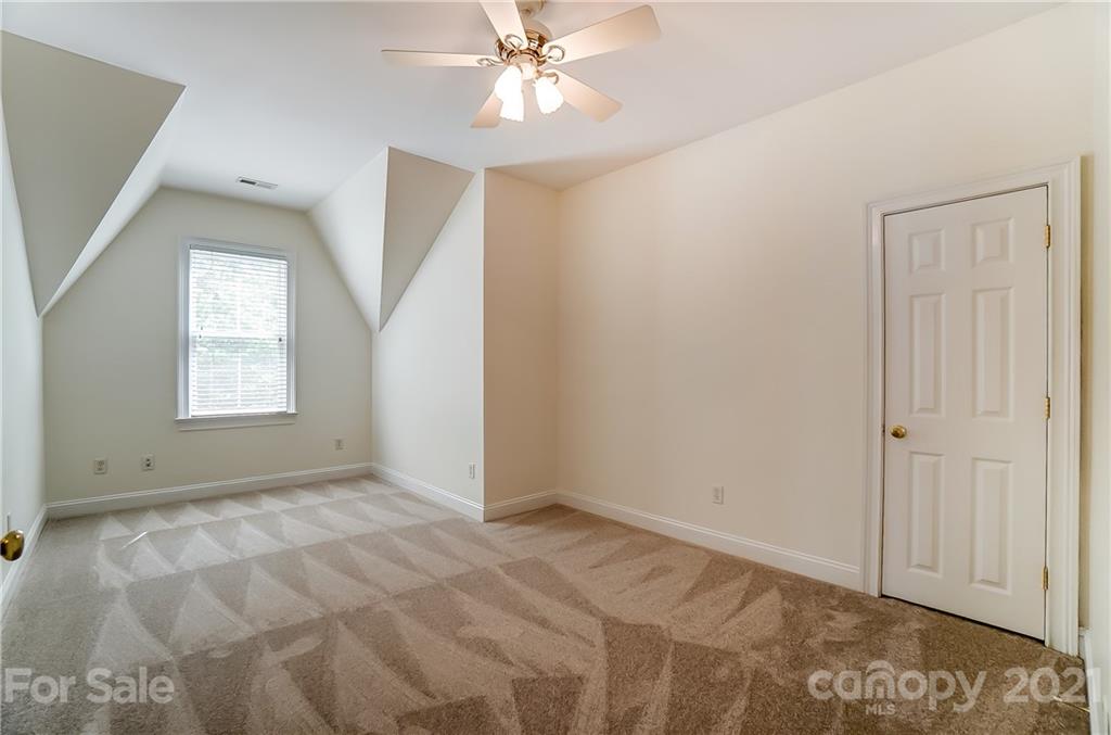 3233 Colonel Springs Way Fort Mill, SC 29708 - Photo 37 of 48 a view of an empty room with window and chandelier fan