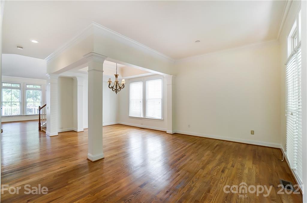 3233 Colonel Springs Way Fort Mill, SC 29708 - Photo 6 of 48 a view of an empty room with wooden floor and a window