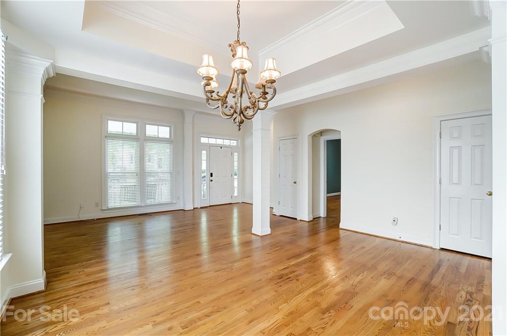 3233 Colonel Springs Way Fort Mill, SC 29708 - Photo 7 of 48 a view of an empty room with wooden floor and a window