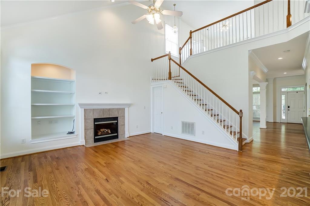 3233 Colonel Springs Way Fort Mill, SC 29708 - Photo 10 of 48 a view of an empty room with wooden floor fireplace and a window