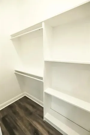 a view of storage and utility room with wooden floor