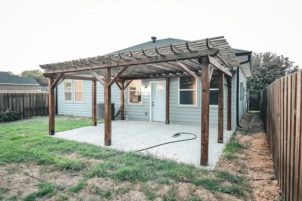 a view of a house with wooden fence
