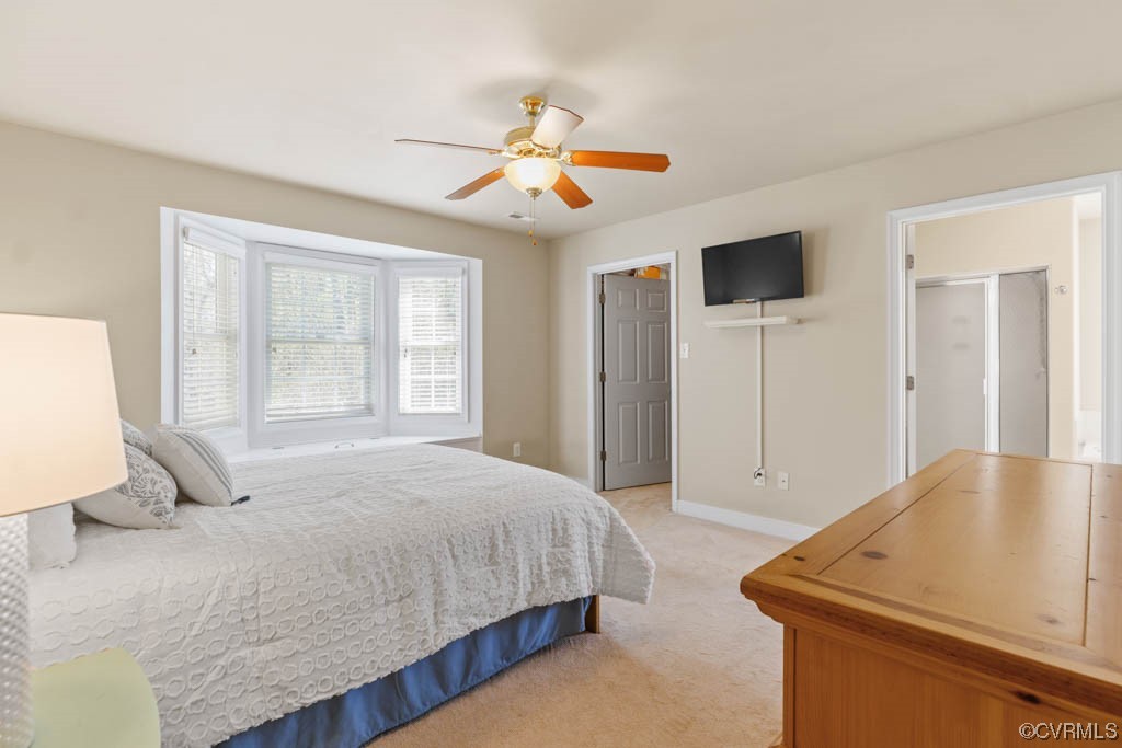 11609 Hillside Road Chester, VA 23831 - Photo 17 of 32 a bedroom with a bed and a chandelier