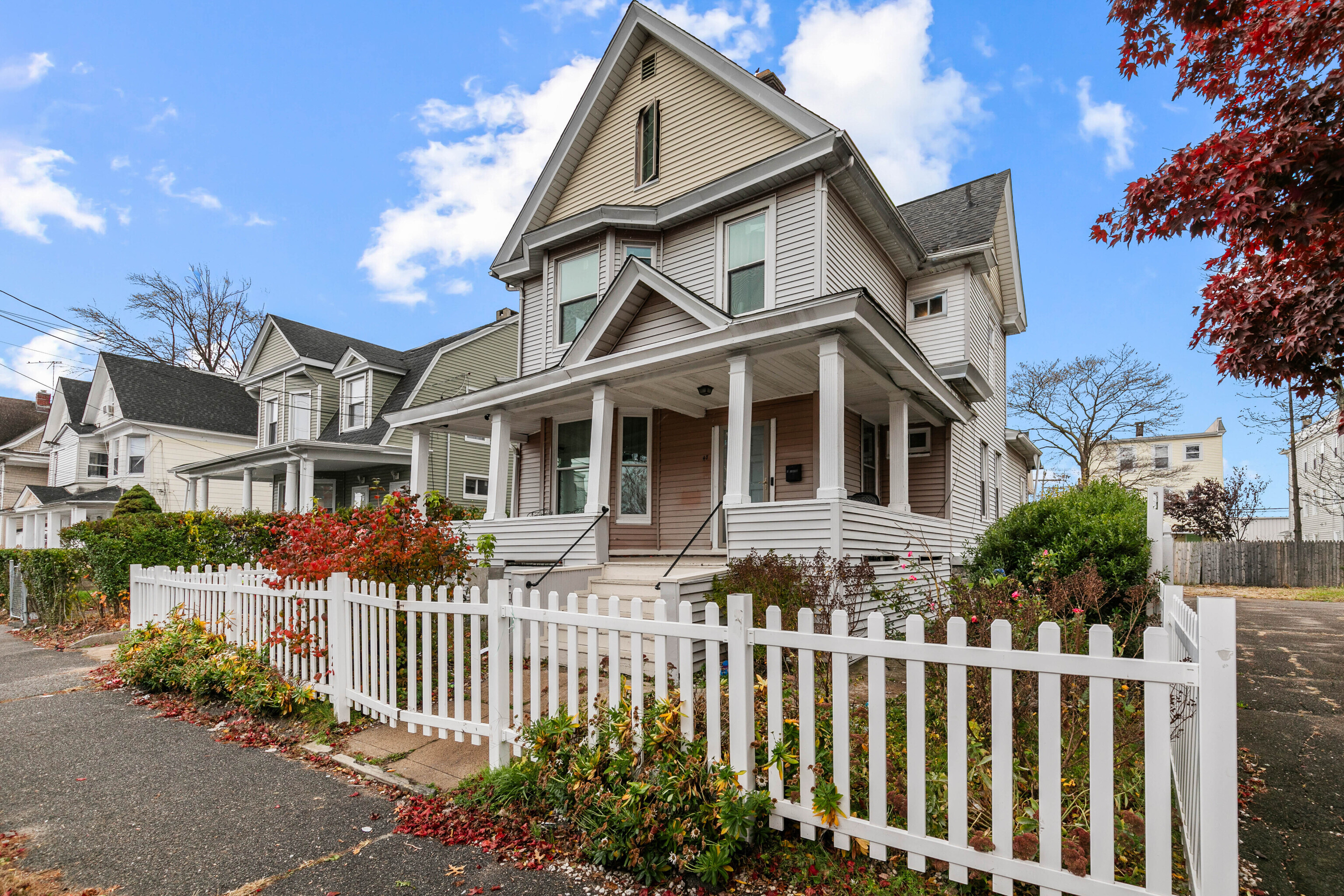 a front view of a house with a garden