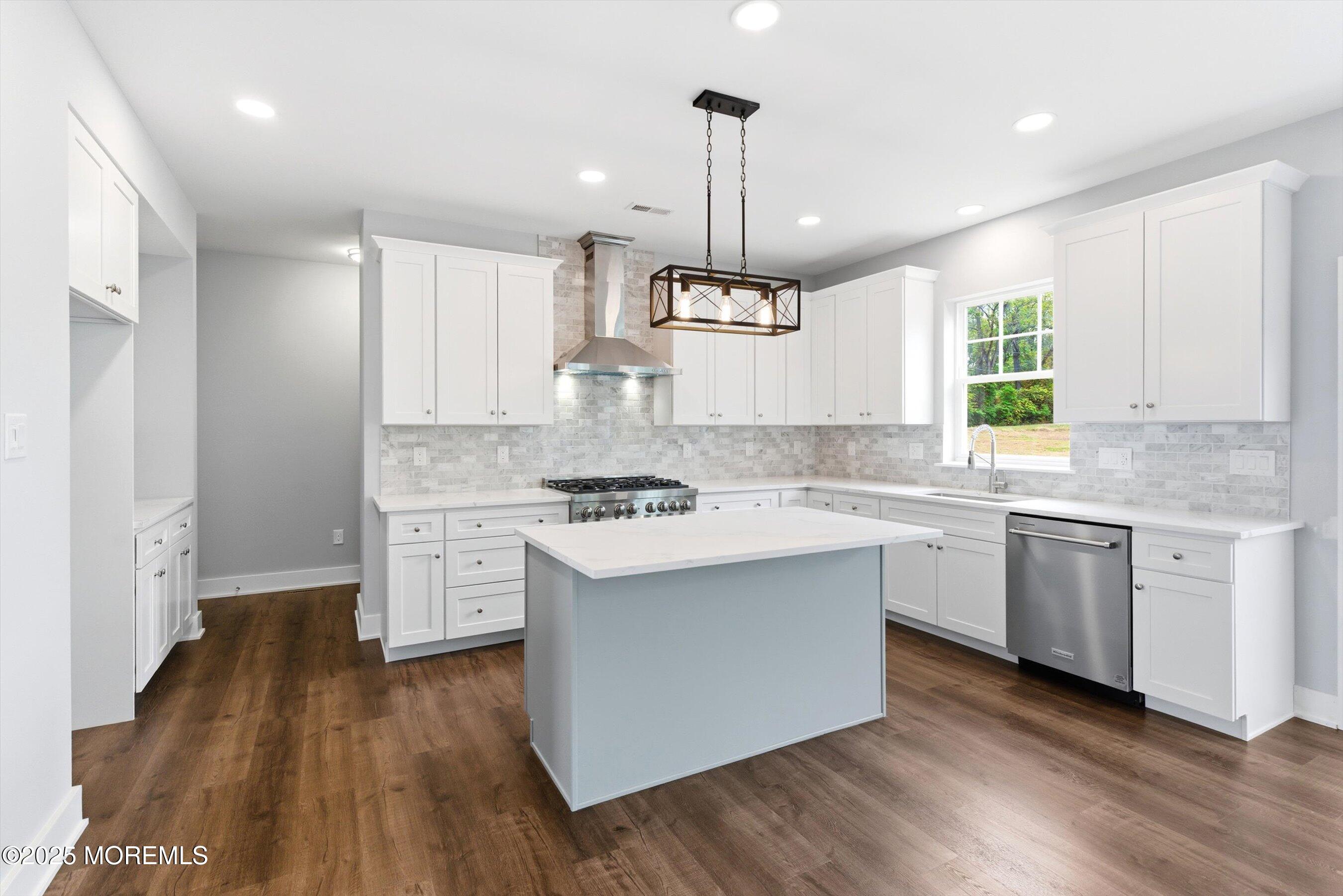 169 Davis Station Road Cream Ridge, NJ 08514 - Photo 17 of 57 a kitchen with granite countertop white cabinets a sink dishwasher and a stove with wooden floor