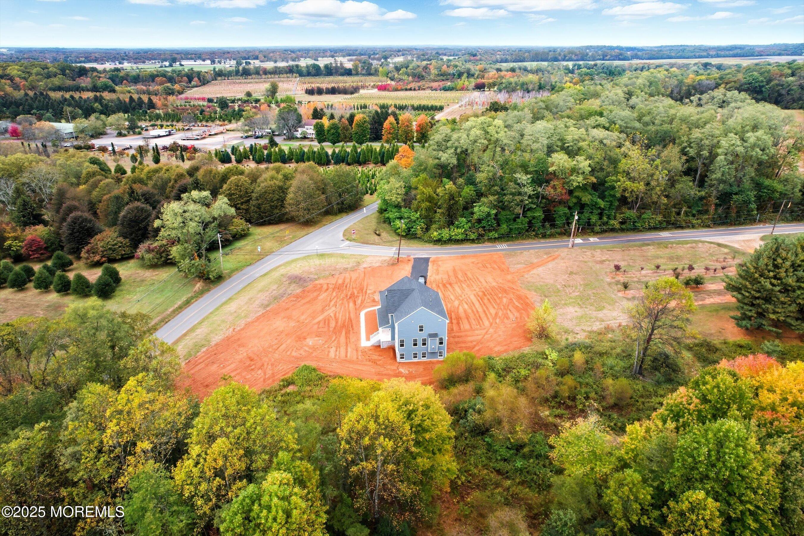 169 Davis Station Road Cream Ridge, NJ 08514 - Photo 3 of 57 an aerial view of a house with a yard and lake view