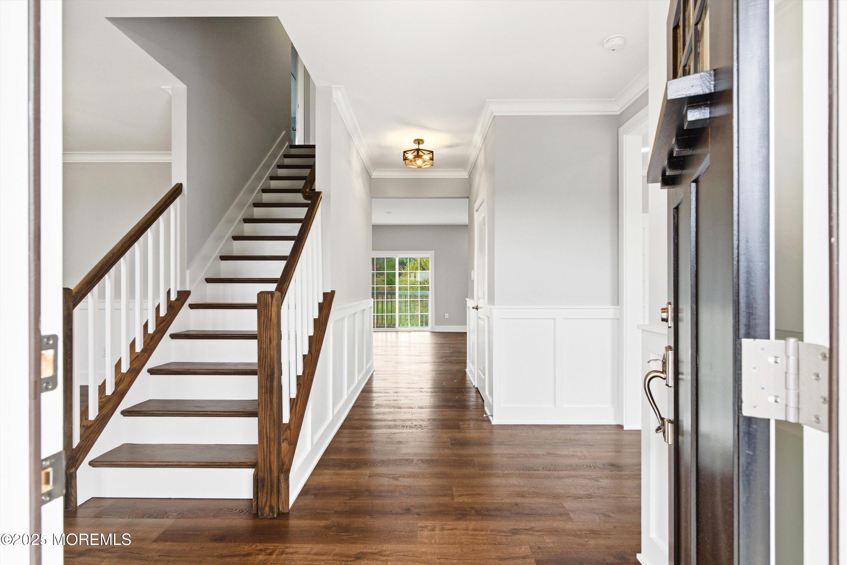 169 Davis Station Road Cream Ridge, NJ 08514 - Photo 6 of 57 a view of a hallway with wooden floor and staircase