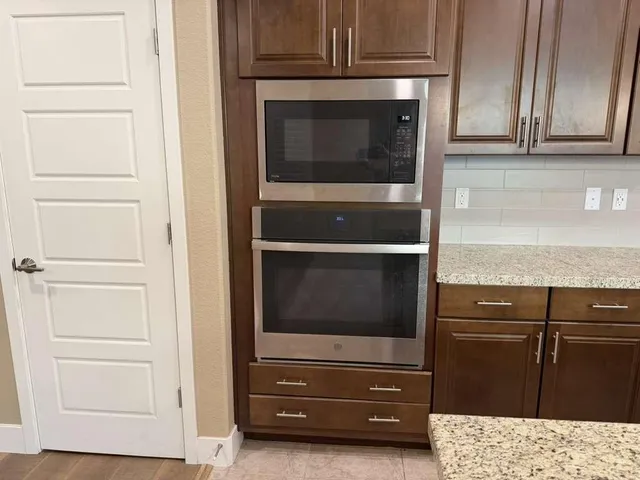 a close view of a stove a microwave and cabinets in a kitchen