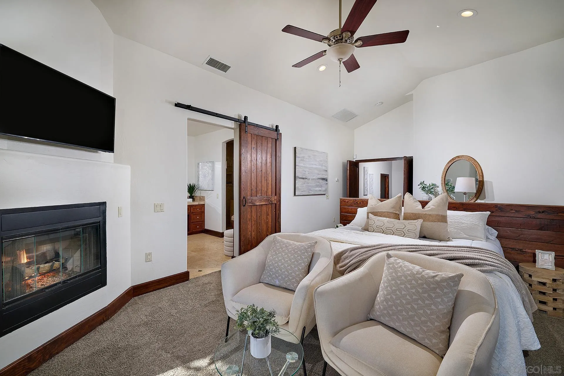 38408 Mesa Road Temecula, CA 92592 - Photo 22 of 57 a bedroom with a bed a flat screen tv and a fireplace