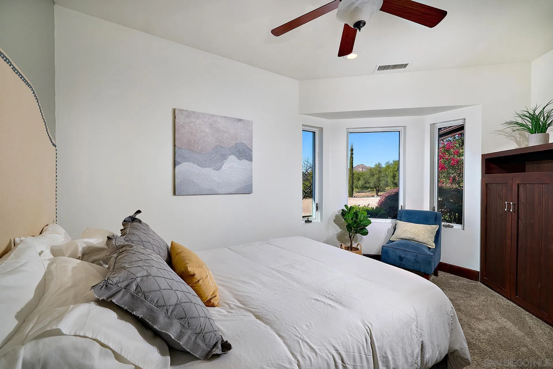 38408 Mesa Road Temecula, CA 92592 - Photo 28 of 57 a bedroom with a large bed and a chandelier fan