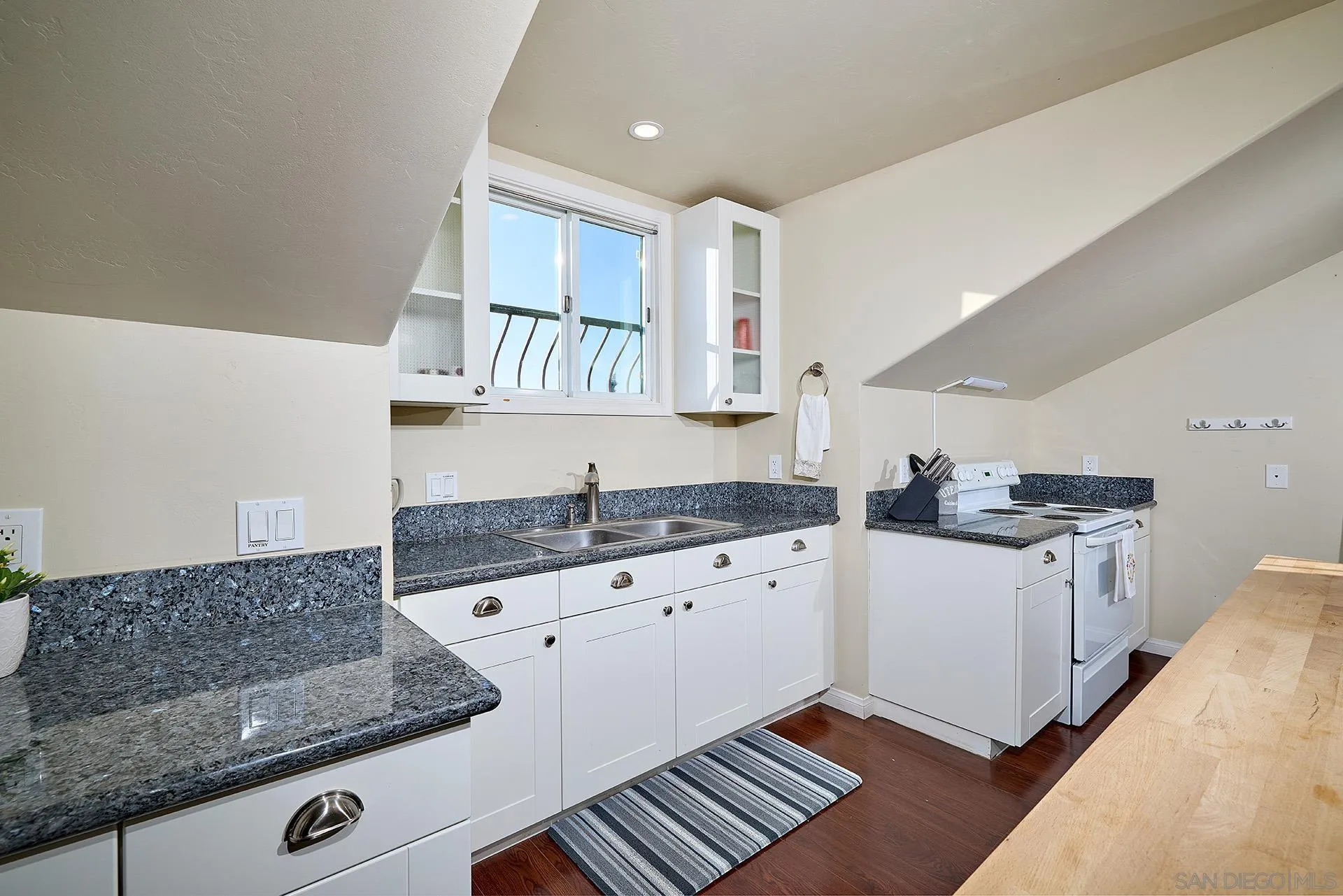 38408 Mesa Road Temecula, CA 92592 - Photo 33 of 57 a kitchen with granite countertop a sink a stove and cabinets