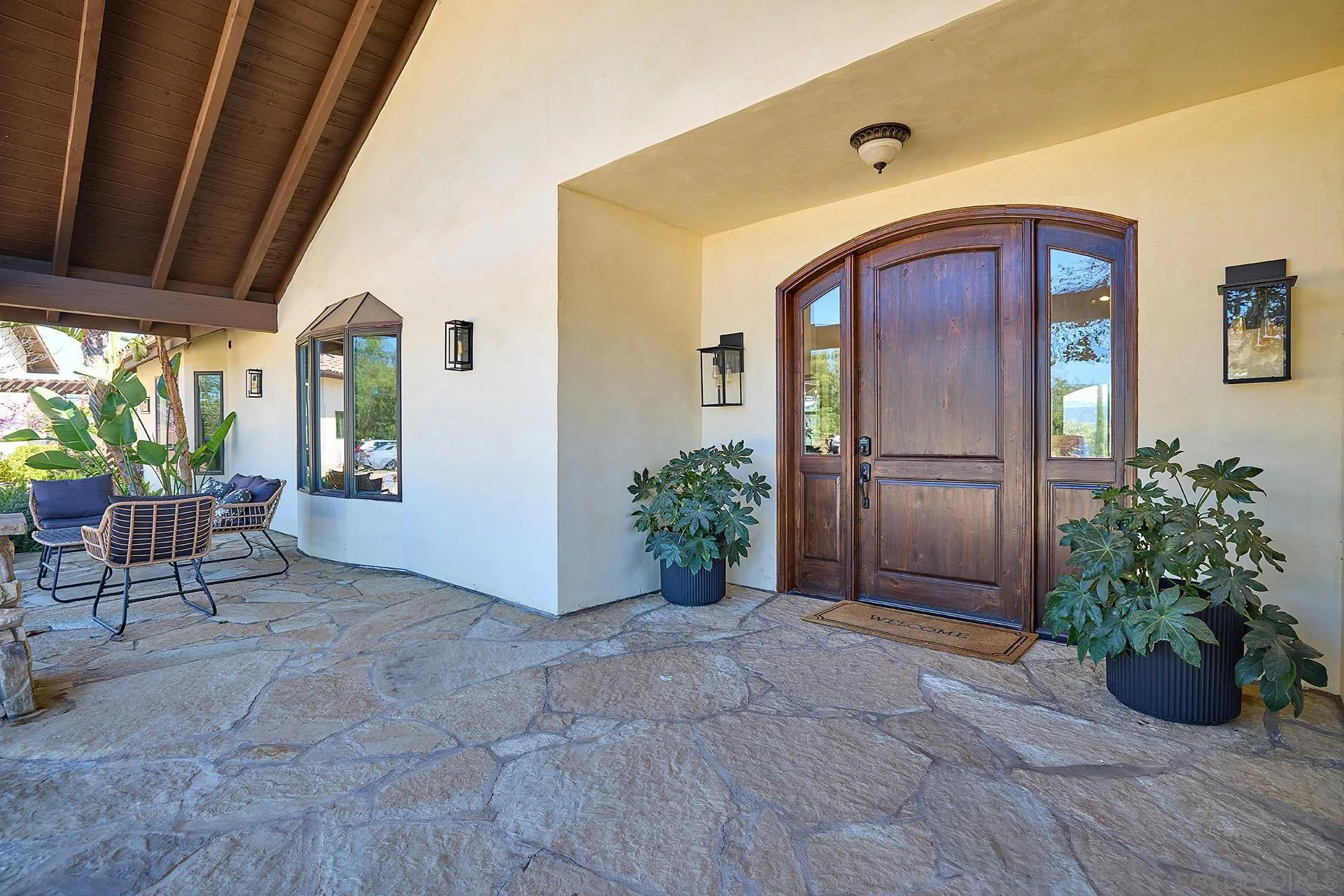 38408 Mesa Road Temecula, CA 92592 - Photo 6 of 57 a view of a porch with chairs and potted plants