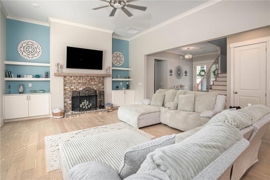 255 Old Town Road Dacula, GA 30019 - Photo 13 of 38 a living room with furniture a flat screen tv and a fireplace
