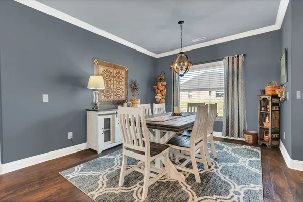 a dining room with furniture and window