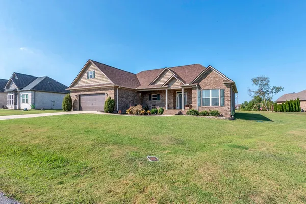 a front view of a house with a yard
