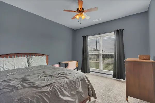 a bedroom with a large bed and a large window