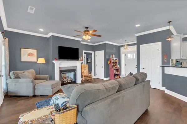 a living room with furniture a fireplace and a flat screen tv