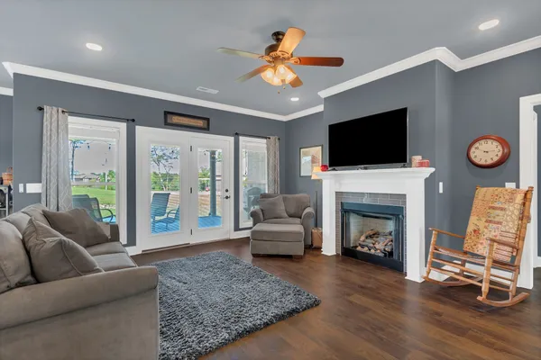 a living room with furniture a fireplace and a flat screen tv