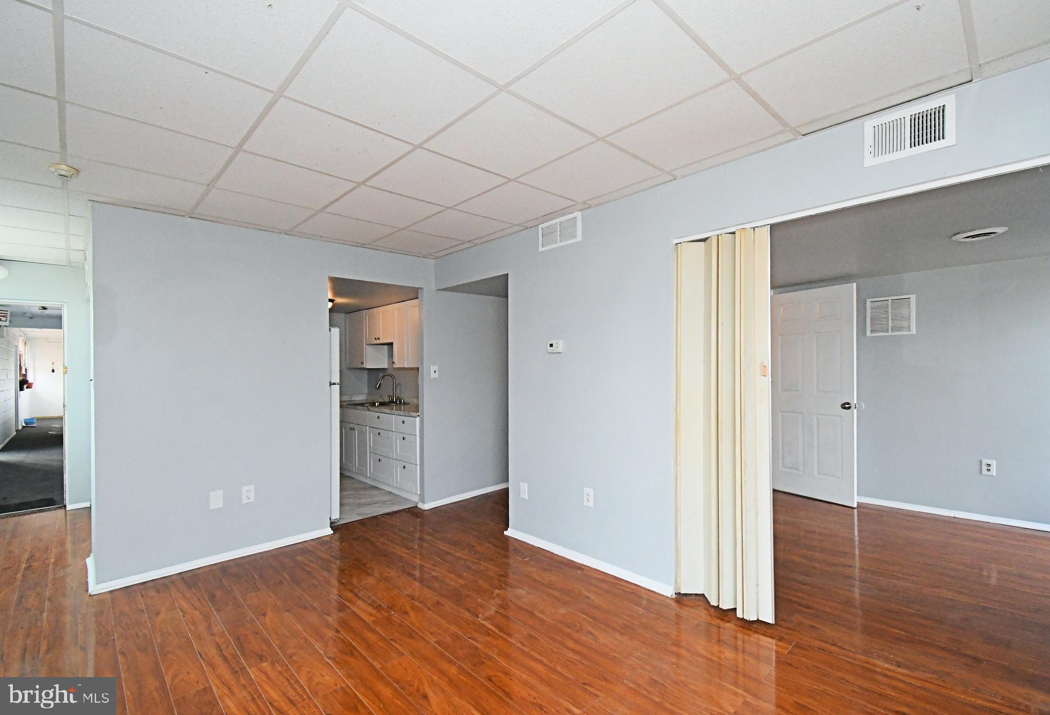 a view of empty room with wooden floor