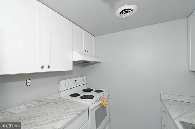 a view of a storage and utility room with washer and dryer