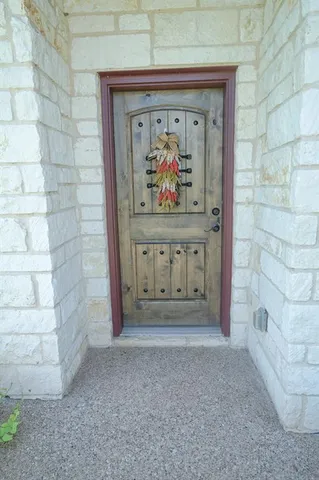 a view of wooden door with glass door