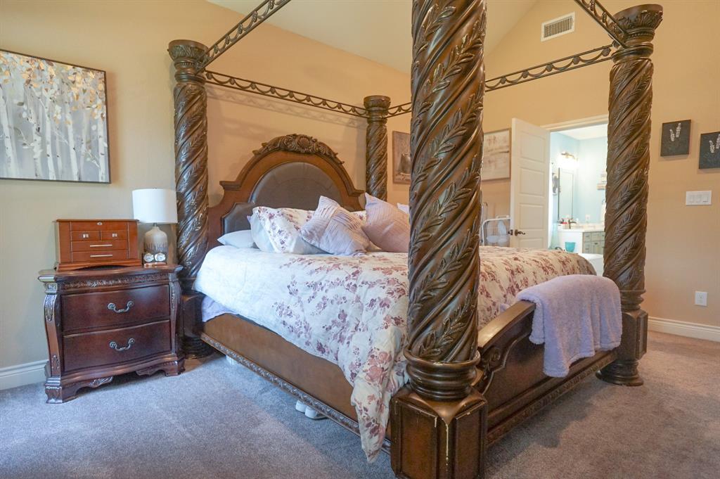 617 Mesquite Tree Road Waco, TX 76705 - Photo 22 of 39 a bedroom with a bed and a mirror
