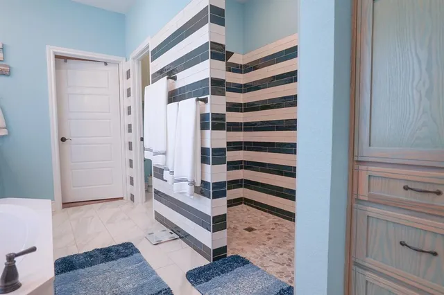 a view of a bedroom with bathroom and staircase