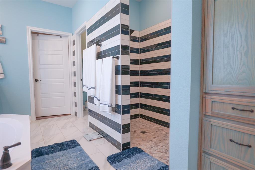 617 Mesquite Tree Road Waco, TX 76705 - Photo 23 of 39 a view of a bedroom with bathroom and staircase