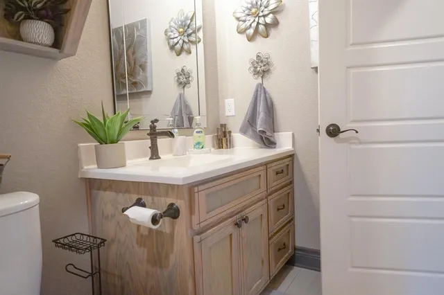 a bathroom with a sink toilet and mirror