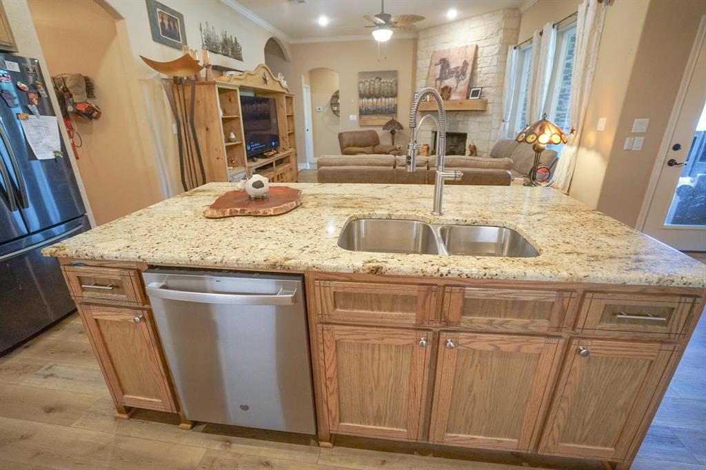 617 Mesquite Tree Road Waco, TX 76705 - Photo 6 of 39 a kitchen with stainless steel appliances granite countertop a sink and a wooden floor