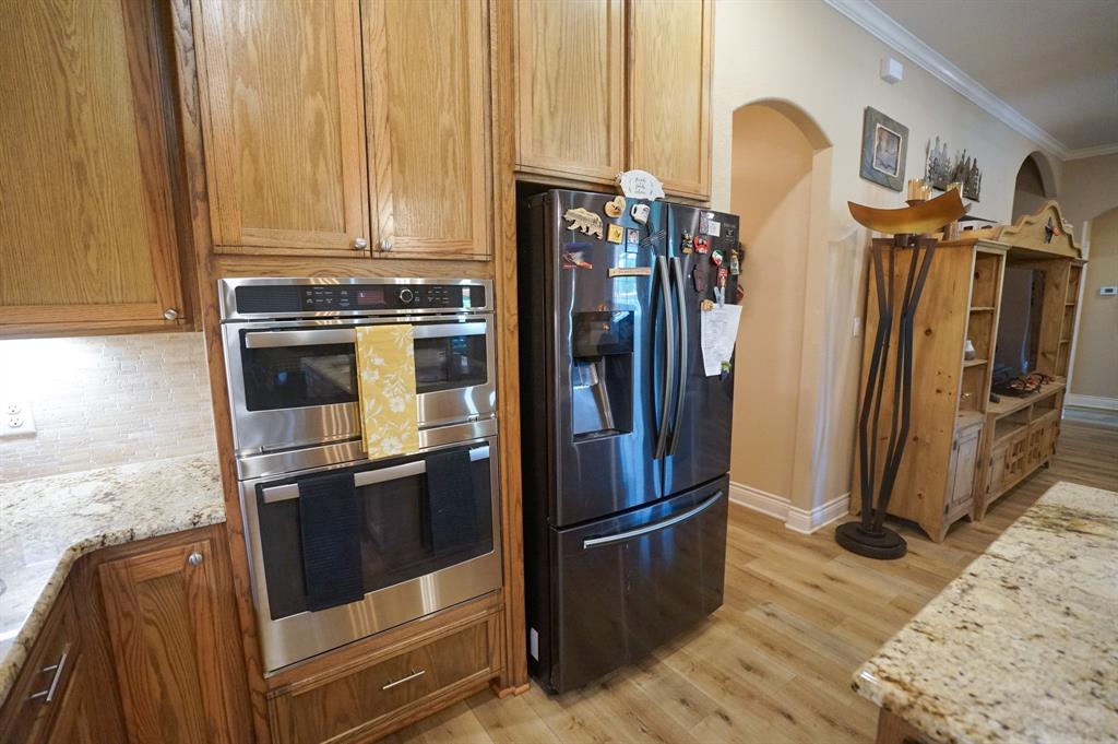 617 Mesquite Tree Road Waco, TX 76705 - Photo 7 of 39 a view of a kitchen with fridge and wooden floor