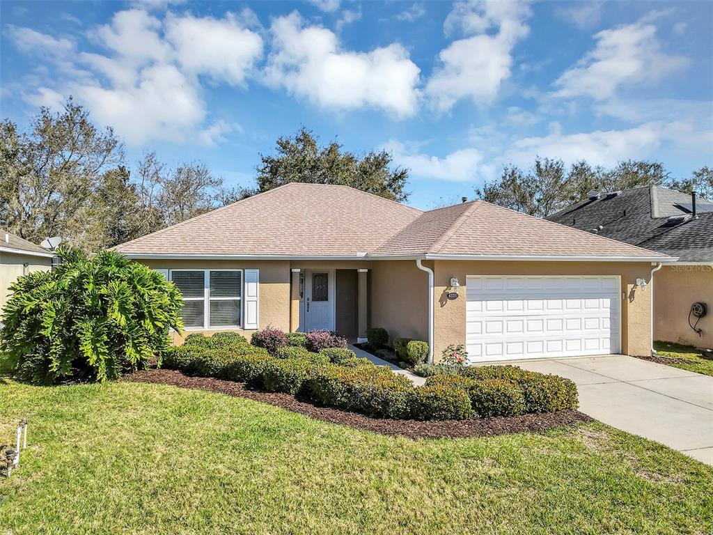 4331 Arlington Ridge Boulevard Leesburg, FL 34748 - Photo 1 of 1 a front view of a house with a yard and garage