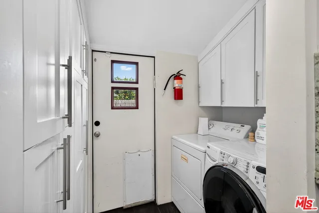 a living room with furniture and large windows