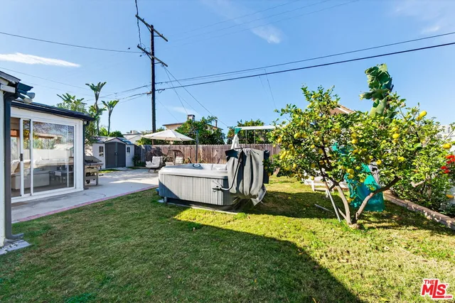 a view of a house with backyard water fountain and sitting area