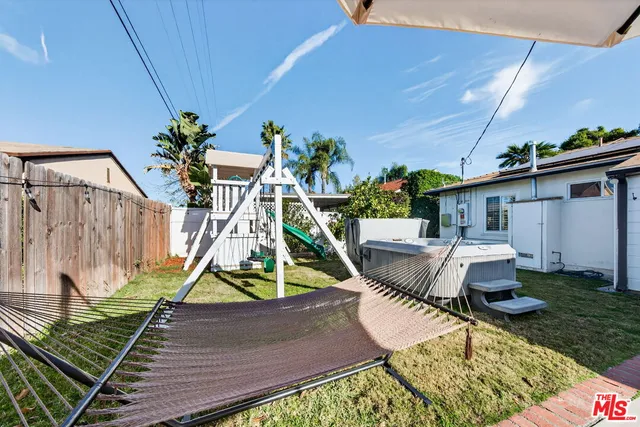 a view of a patio with a table and chairs under an umbrella