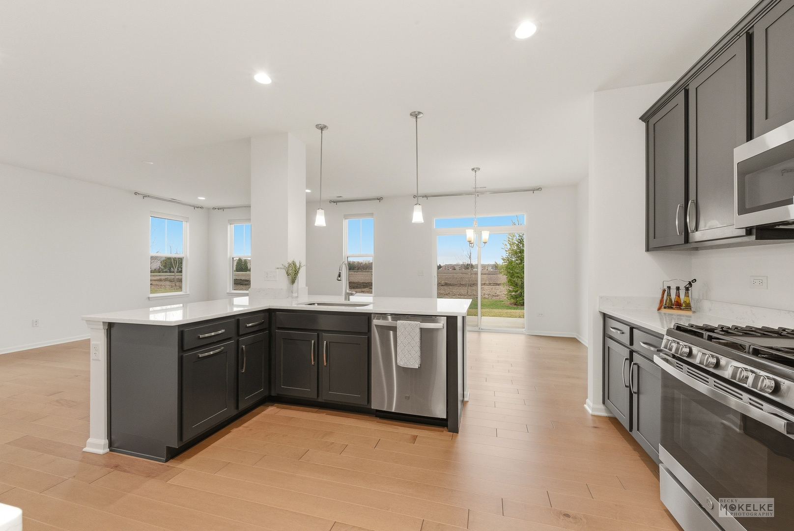 4184 Calder Lane Aurora, IL 60504 - Photo 16 of 35 a large kitchen with stainless steel appliances granite countertop a stove and a sink