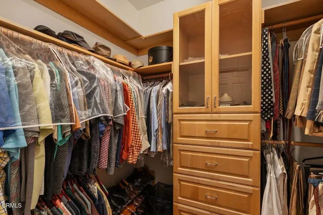 a view of walk in closet with empty racks