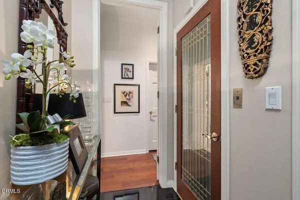 a view of a hallway with furniture and potted plant