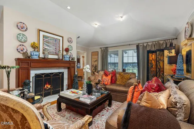 a living room with furniture and a fireplace