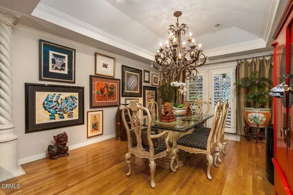 a view of a dining room with furniture wooden floor and chandelier